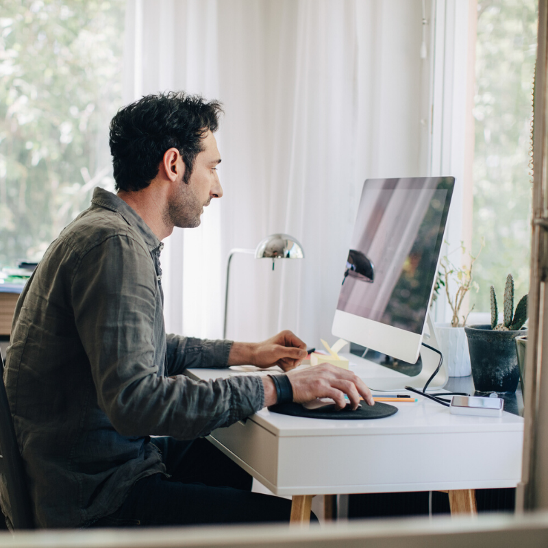 Man sitting at a computer at home